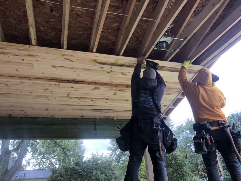 Our crew installing tongue and groove on deck ceiling